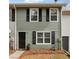 Well-maintained townhouse with green siding, black shutters, and tidy front landscaping at 4282 Worth Nw St, Acworth, GA 30101