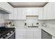Modern kitchen with white cabinets, stainless steel appliances, and quartz countertops at 4282 Worth Nw St, Acworth, GA 30101