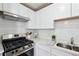 Modern kitchen with white cabinets, stainless steel appliances, and subway tile backsplash at 4282 Worth Nw St, Acworth, GA 30101