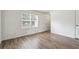 Cozy living room featuring wood-look flooring, fresh white paint, and natural light at 4282 Worth Nw St, Acworth, GA 30101