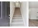 Inviting staircase leading to the upper level, with neutral carpeting and white walls at 4282 Worth Nw St, Acworth, GA 30101
