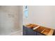 Bathroom features walk in shower with niche and a bright window at 5694 Brendlynn Dr, Suwanee, GA 30024