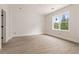 Well-lit bedroom with a large window overlooking the backyard at 5694 Brendlynn Dr, Suwanee, GA 30024