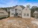 Stunning two-story brick home with an elegant design and spacious front yard with unfinished landscaping at 5694 Brendlynn Dr, Suwanee, GA 30024