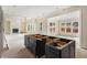 Spacious kitchen island with dark cabinets and unfinished countertops, perfect for entertaining at 5694 Brendlynn Dr, Suwanee, GA 30024