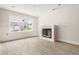 Bright living room with a fireplace and a large window showcasing the outdoor view at 5694 Brendlynn Dr, Suwanee, GA 30024