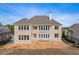 New construction rear exterior view featuring multiple windows and a spacious backyard at 5694 Brendlynn Dr, Suwanee, GA 30024