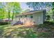 A wonderful backyard features lush green trees and a house with steps to the back entrance at 2041 W Flat Shoals Ter, Decatur, GA 30034