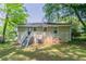 A nice backyard with a house that has steps leading to the back entrance and lush green trees at 2041 W Flat Shoals Ter, Decatur, GA 30034