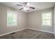 Bedroom with neutral paint, a ceiling fan with lighting, carpeted floor, and large windows at 2041 W Flat Shoals Ter, Decatur, GA 30034