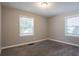 Bedroom with neutral paint, carpeted floor, and two large windows at 2041 W Flat Shoals Ter, Decatur, GA 30034
