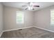Bedroom with neutral paint, a ceiling fan with lighting, carpeted floor, and large windows at 2041 W Flat Shoals Ter, Decatur, GA 30034