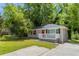 Inviting single-level home with a bright red front door, front porch, and a green lawn at 2041 W Flat Shoals Ter, Decatur, GA 30034