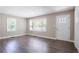 A well-lit living room with wood-look floors, fresh paint, and a front door with large windows at 2041 W Flat Shoals Ter, Decatur, GA 30034