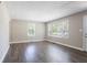 Bright living room featuring wood-look flooring, neutral walls, and ample natural light from the large windows at 2041 W Flat Shoals Ter, Decatur, GA 30034