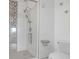 Modern bathroom features a sleek glass shower, gray accent tiles, and updated toilet at 3475 Oak Valley Rd # 660, Atlanta, GA 30326