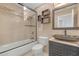 Updated bathroom with stylish vanity, vessel sink, and a glass-enclosed shower over tub at 3475 Oak Valley Rd # 660, Atlanta, GA 30326