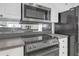 Kitchen featuring updated appliances including oven, microwave, and refrigerator at 3475 Oak Valley Rd # 660, Atlanta, GA 30326