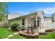 Backyard patio seating area features manicured landscaping and a covered patio with access to the home at 624 Spanish Oak Dr, Acworth, GA 30102