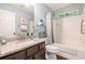 Well-lit bathroom features granite countertops and a shower-tub combination with tiled surround at 624 Spanish Oak Dr, Acworth, GA 30102