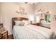 Bedroom with hardwood floors, a ceiling fan, neutral walls, and a bed with a patterned comforter at 624 Spanish Oak Dr, Acworth, GA 30102