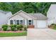 Charming single-story home with well-manicured landscaping, a one car garage, and neutral toned siding at 624 Spanish Oak Dr, Acworth, GA 30102