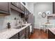 Kitchen with stainless steel appliances, granite countertops, tile backsplash, and dark cabinets with chrome hardware at 624 Spanish Oak Dr, Acworth, GA 30102