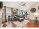 Bright living room with hardwood floors, a ceiling fan, neutral walls, and large windows that let in lots of natural light at 624 Spanish Oak Dr, Acworth, GA 30102