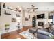 Spacious living room with hardwood floors, fireplace, neutral paint, ample shelving, and large windows that let in natural light at 624 Spanish Oak Dr, Acworth, GA 30102