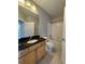 Bathroom with black granite countertops, wood cabinets, toilet, shower, and tub at 799 Hammond Dr # 321, Atlanta, GA 30328