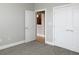 Cozy bedroom featuring neutral walls and carpet flooring with closet and doorway in background at 799 Hammond Dr # 321, Atlanta, GA 30328