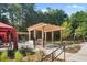 Community grill and fire pit area with pergola in a beautiful landscaped setting at 799 Hammond Dr # 321, Atlanta, GA 30328