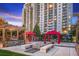 Community area with a fire pit, grilling area and picnic tables and red shaded cabanas in a beautiful landscaped setting at 799 Hammond Dr # 321, Atlanta, GA 30328