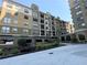 Low angle shows the tan facade of a mid-rise residential building with balconies at 799 Hammond Dr # 321, Atlanta, GA 30328