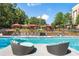 Community pool with lounge seating and red shaded cabanas in a beautiful landscaped setting at 799 Hammond Dr # 321, Atlanta, GA 30328