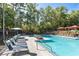 Community pool with lounge seating and landscaping in a beautiful wooded setting at 799 Hammond Dr # 321, Atlanta, GA 30328