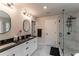 Bright bathroom featuring dual sinks, granite countertop, shower and modern finishes at 842 Bridgewater Sw St, Atlanta, GA 30310