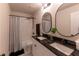 Bathroom featuring dual sinks, granite countertop and shower with tub at 842 Bridgewater Sw St, Atlanta, GA 30310