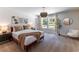 Stylish bedroom features neutral walls, carpet, and an eye-catching chandelier above the bed at 842 Bridgewater Sw St, Atlanta, GA 30310