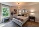 Bright bedroom with a large window and modern light fixture and mirrors at 842 Bridgewater Sw St, Atlanta, GA 30310