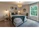Cozy bedroom featuring neutral tones, stylish lighting, and a serene view from the bright window at 842 Bridgewater Sw St, Atlanta, GA 30310