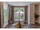 Chic dining area featuring a round table, stylish chairs, and large windows with backyard views at 842 Bridgewater Sw St, Atlanta, GA 30310
