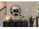 Stylish entryway decor with modern black console table, mirror, and staircase view at 842 Bridgewater Sw St, Atlanta, GA 30310