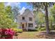 Charming two-story home with white siding, a red front door, and a beautifully landscaped front yard at 842 Bridgewater Sw St, Atlanta, GA 30310