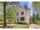 Bright two-story home with white siding, dark trim, and front yard with mature trees at 842 Bridgewater Sw St, Atlanta, GA 30310
