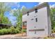 Modern home exterior with a spacious garage and a charming wooden balcony surrounded by lush greenery at 842 Bridgewater Sw St, Atlanta, GA 30310