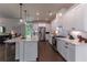 A modern kitchen boasts white cabinetry, stainless appliances, and a spacious island with bar seating at 842 Bridgewater Sw St, Atlanta, GA 30310