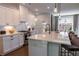 A well lit kitchen featuring white cabinets, a large island, stainless steel appliances, and backyard views at 842 Bridgewater Sw St, Atlanta, GA 30310