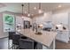 Bright kitchen with white cabinets, quartz countertops, a large island and modern stainless steel appliances at 842 Bridgewater Sw St, Atlanta, GA 30310