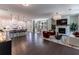 Open-concept living room, kitchen, and dining area with hardwood floors and a fireplace at 842 Bridgewater Sw St, Atlanta, GA 30310